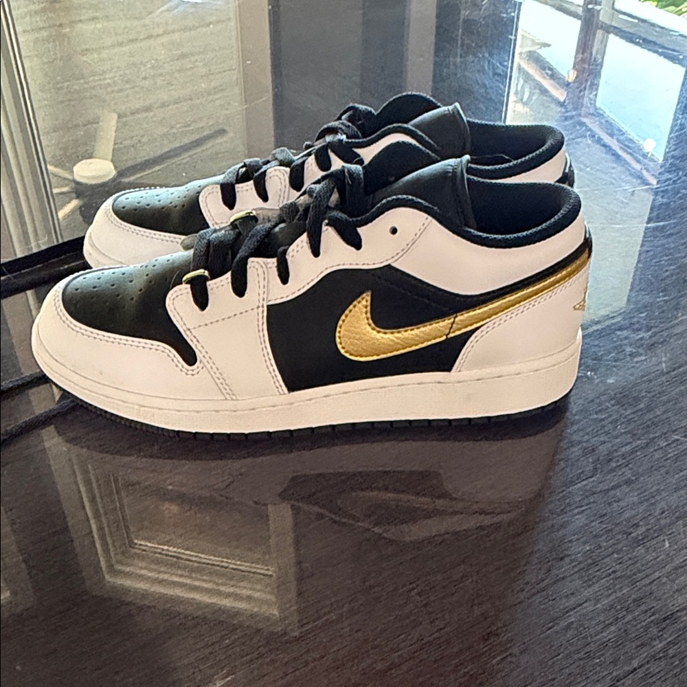 Air Jordan 1 Low "Gold Swoosh" sneakers in a white, black, and gold colorway